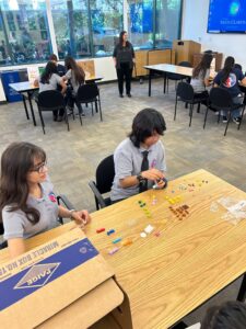 Youth in Government students doing an interactive lego activity led by the Engineering department.