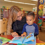 Woman and child reading a book in the Library