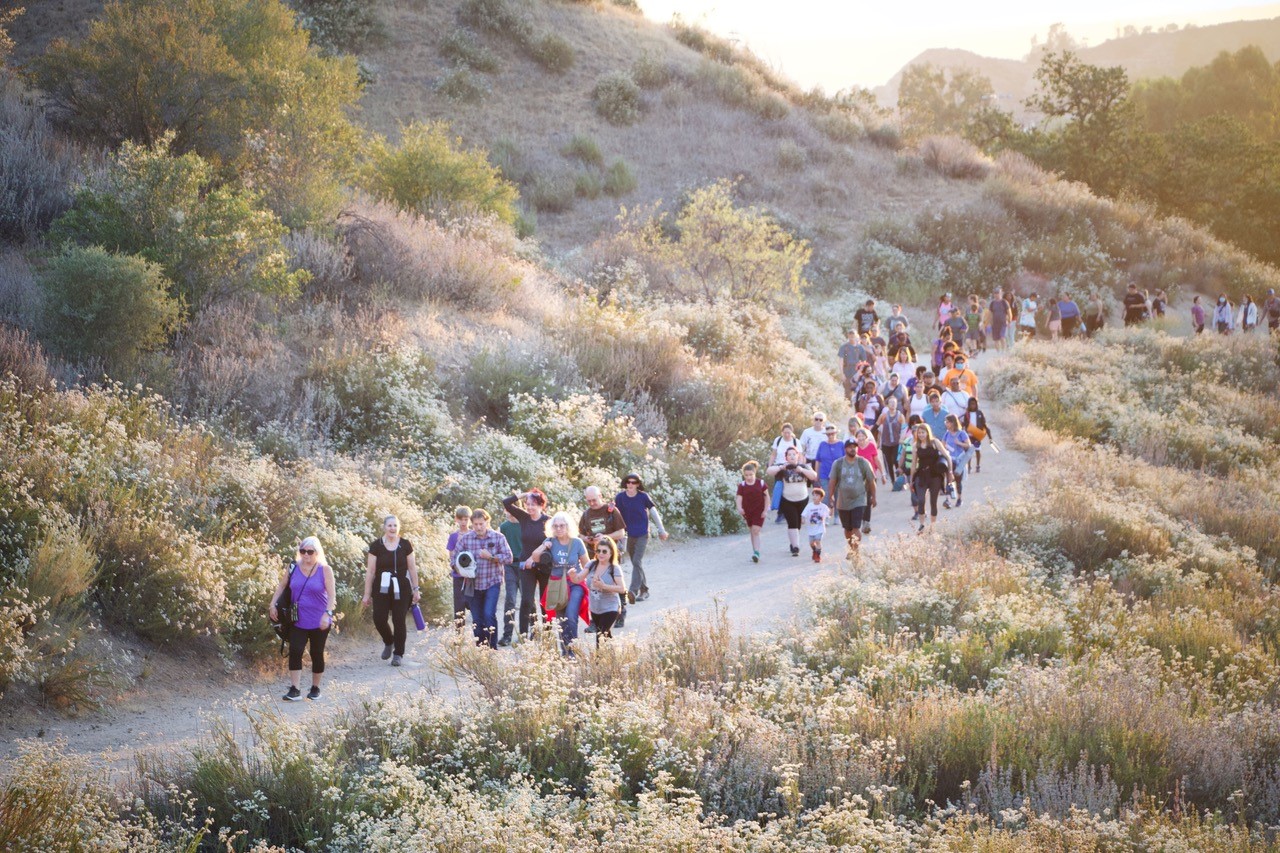 Community members hiking on a trail together