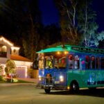 Transit bus driving through neighborhood with holiday lights