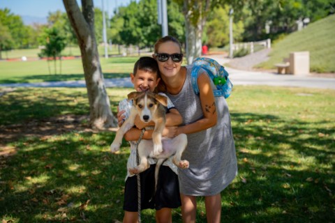 A mother and son with their newly adopted dog
