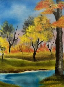 Beautiful landscape with orange, yellow and green trees and a beautiful river flowing through