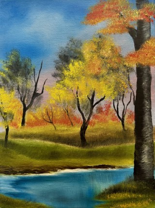 Beautiful landscape with orange, yellow and green trees and a beautiful river flowing through