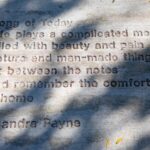 Photo of poetry etched on the sidewalk