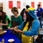 Teens dressed up doing crafts