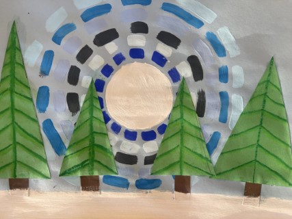 Pine trees in front of a grey and blue landscape