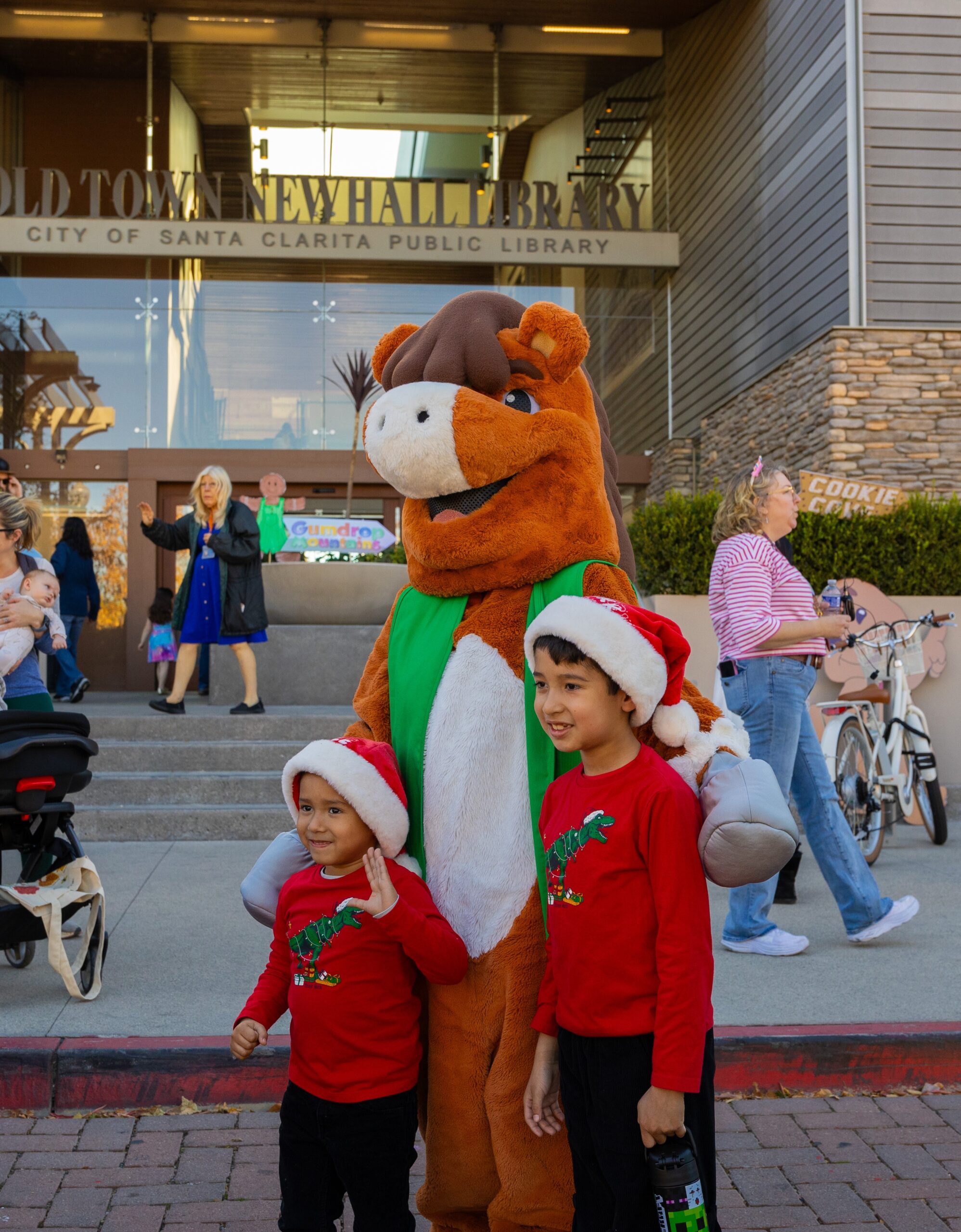 Sammy Clarita mascot with two children at the Family Literacy Festival. For more information about the Family Literacy Festival, please visit SantaClaritaLibrary.com