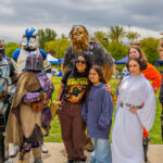Star Wars characters posing with a mother and child.