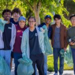 Volunteers holding trash bags as they participate in Neighborhood Cleanup.