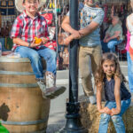 Kids sitting on hay bale