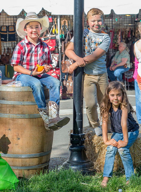 Kids sitting on hay bale