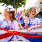 Fourth of July attendees waiving American flags