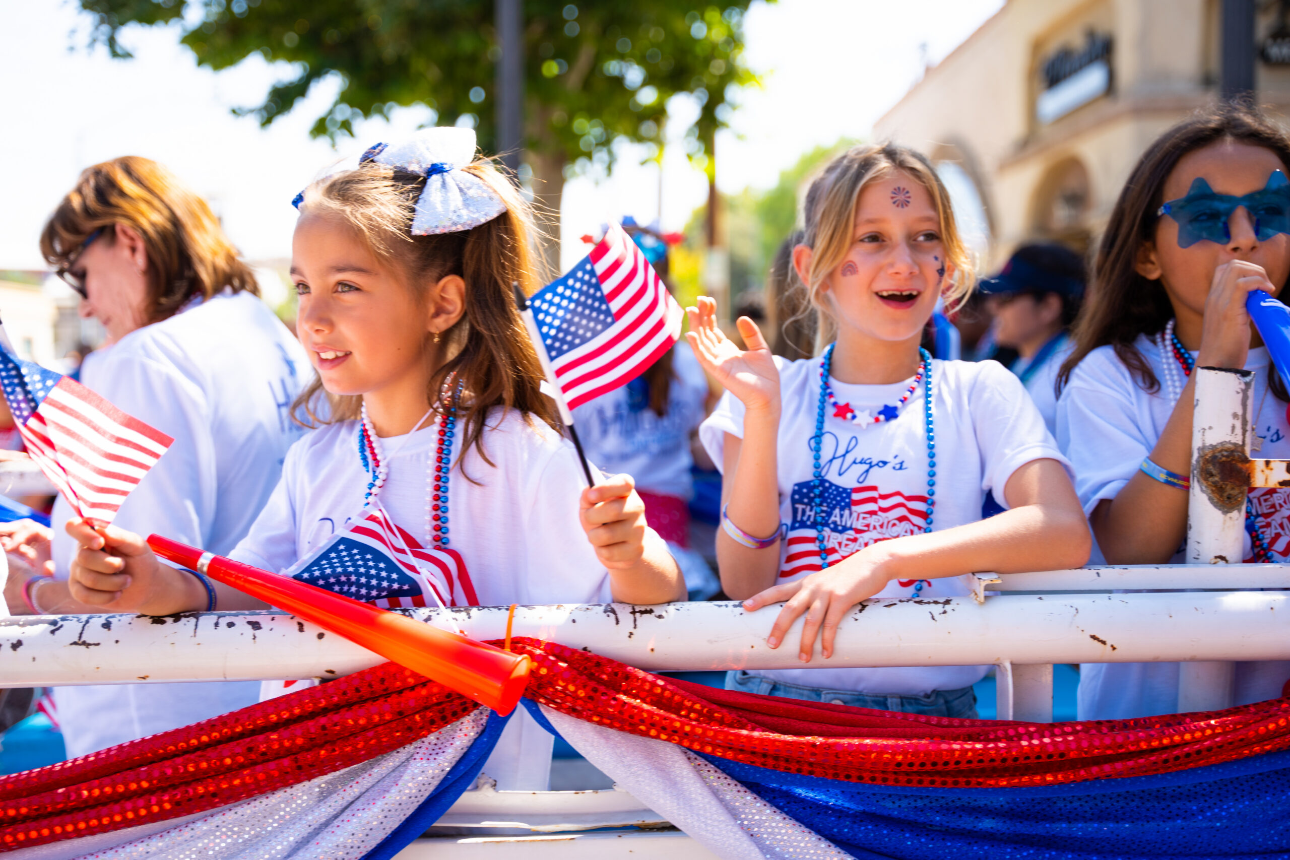 Fourth of July attendees waiving American flags